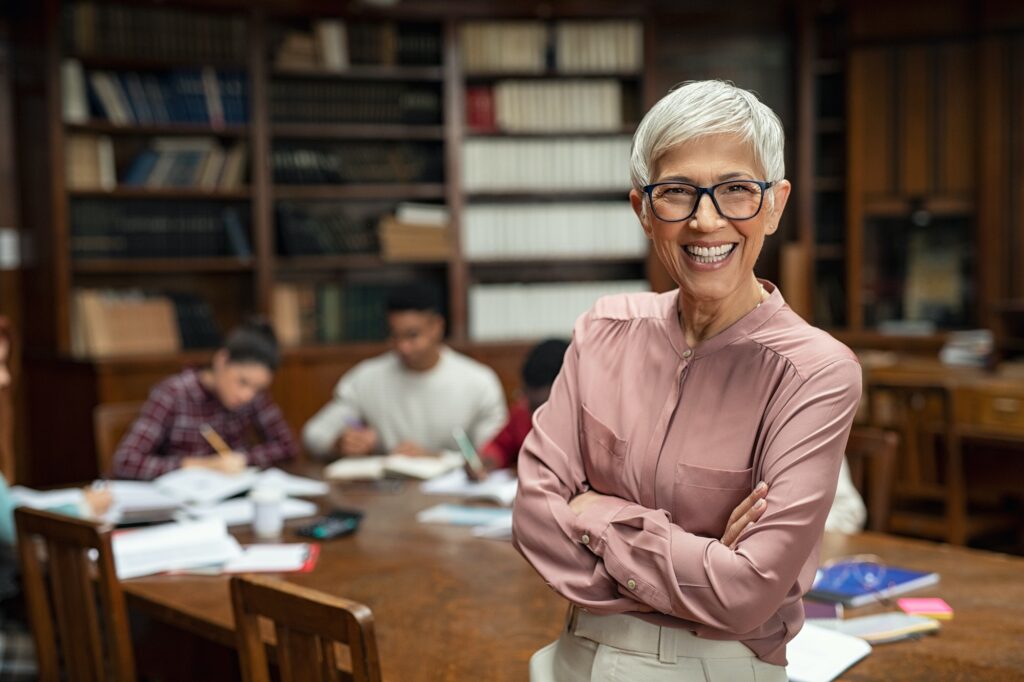 Smiling university professor in library